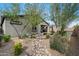 A desert landscaped backyard with a dry creek bed and covered patio off the back of the home at 11623 W Marguerite Ave, Avondale, AZ 85323