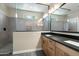 Modern bathroom featuring dual sinks, granite countertops, and a glass-enclosed walk-in shower at 11623 W Marguerite Ave, Avondale, AZ 85323
