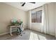Bright bedroom featuring a modern desk, comfortable chair, and sun-filled window at 11623 W Marguerite Ave, Avondale, AZ 85323