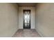 An inviting covered entrance with stylish pavers and a modern black metal door at 11623 W Marguerite Ave, Avondale, AZ 85323
