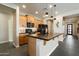 Modern kitchen featuring an island, wooden cabinets, and pendant lighting at 11623 W Marguerite Ave, Avondale, AZ 85323