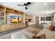 Bright living room boasts a custom entertainment center and views into dining and kitchen spaces at 11623 W Marguerite Ave, Avondale, AZ 85323