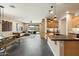 Open-concept space with kitchen island, dining, and comfortable living area with patio access at 11623 W Marguerite Ave, Avondale, AZ 85323
