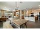 Spacious living area, adjacent to a modern kitchen, featuring a dining table at 11623 W Marguerite Ave, Avondale, AZ 85323