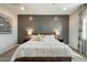 Inviting main bedroom features a stylish accent wall, plush bedding, and soft ambient lighting at 11623 W Marguerite Ave, Avondale, AZ 85323
