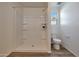 Bright bathroom featuring new walk-in shower, toilet, window, and modern fixtures, creating a clean and functional space at 1179 N 13Th St, Coolidge, AZ 85128