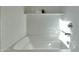 Close-up of a pristine white bathtub with white subway tile and shelf to keep toiletries close at hand at 1179 N 13Th St, Coolidge, AZ 85128