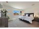 Bedroom with a queen-sized bed, plush bedding, side tables with lamps, carpeted floors, and bright window at 1179 N 13Th St, Coolidge, AZ 85128