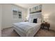 Cozy bedroom with a plush queen bed, side tables, lamps, and a sunlit window at 1179 N 13Th St, Coolidge, AZ 85128
