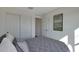 Cozy bedroom featuring a plush bed with a gray patterned comforter, complemented by a sliding door closet at 1179 N 13Th St, Coolidge, AZ 85128