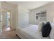 Bedroom featuring carpeted floors, queen bed with white bedding, side tables, and a bright window at 1179 N 13Th St, Coolidge, AZ 85128