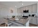 Bright kitchen features a granite island, stainless appliances and stylish white cabinets at 1179 N 13Th St, Coolidge, AZ 85128