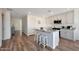 Bright kitchen features a granite island, stainless appliances and stylish white cabinets at 1179 N 13Th St, Coolidge, AZ 85128