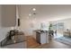 Bright open floor plan showcases a modern kitchen with an island, granite countertops, and stainless appliances at 1179 N 13Th St, Coolidge, AZ 85128