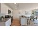 Bright, modern kitchen with stainless steel appliances, granite countertops, island with seating, and dining area at 1179 N 13Th St, Coolidge, AZ 85128