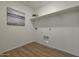 Bright laundry room equipped with upper shelf and hookups for a washer and dryer at 1179 N 13Th St, Coolidge, AZ 85128