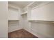 Functional walk-in closet with multiple wooden hanging rods and upper shelving for optimal storage solutions at 1179 N 13Th St, Coolidge, AZ 85128
