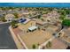 Large backyard with a covered patio, fully enclosed with block fencing and views of the neighborhood at 13171 W Redfield Rd, Surprise, AZ 85379