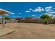 Wide view of backyard showcasing the concrete patio, block wall, and desert landscaping at 13171 W Redfield Rd, Surprise, AZ 85379