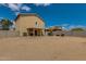 Backyard view featuring a covered patio, block wall, and the exterior of the two-story home at 13171 W Redfield Rd, Surprise, AZ 85379