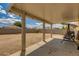 Covered patio and spacious backyard with a swing and a block wall fence at 13171 W Redfield Rd, Surprise, AZ 85379