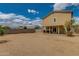 Expansive backyard with block wall fencing and a covered patio attached to the house at 13171 W Redfield Rd, Surprise, AZ 85379