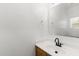 Bright bathroom with a single sink wooden vanity with solid white countertop at 13171 W Redfield Rd, Surprise, AZ 85379