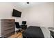 Bedroom with dark wood floors, neutral walls, dark wood dresser and a desk at 13171 W Redfield Rd, Surprise, AZ 85379