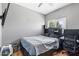Gray bedroom with a black queen size bed, window view, and built-in shelves in headboard at 13171 W Redfield Rd, Surprise, AZ 85379