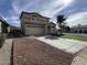 View of a two-story home highlighting the driveway and front exterior at 13171 W Redfield Rd, Surprise, AZ 85379
