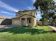 Charming two-story home featuring well-maintained front yard and attached two-car garage at 13171 W Redfield Rd, Surprise, AZ 85379