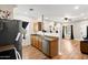 Well lit kitchen with wood floors, stainless steel appliances, and stainless steel double sink at 13171 W Redfield Rd, Surprise, AZ 85379