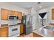 Kitchen featuring stainless steel refrigerator, wood cabinets and tile countertops at 13171 W Redfield Rd, Surprise, AZ 85379