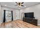 Living room with wood floors, window, television, and natural light at 13171 W Redfield Rd, Surprise, AZ 85379