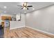 A spacious living room area featuring new hardwood floors and a ceiling fan at 13171 W Redfield Rd, Surprise, AZ 85379