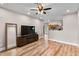 Bright living room offering hardwood floors, television, and open floor plan at 13171 W Redfield Rd, Surprise, AZ 85379