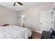 Clean main bedroom features wood floors, ceiling fan, and door to ensuite bathroom at 13171 W Redfield Rd, Surprise, AZ 85379