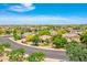 An aerial view of the community showcases lush landscaping and well-maintained homes under a clear blue sky at 15216 W Westview Dr, Goodyear, AZ 85395