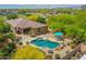 The home features a private pool, patio space, and lush landscaping, creating a perfect backyard retreat at 15216 W Westview Dr, Goodyear, AZ 85395