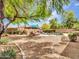A beautiful pool with lounge chairs, surrounded by well-maintained landscaping, creates a serene outdoor retreat at 15216 W Westview Dr, Goodyear, AZ 85395