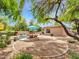 A stunning backyard showcases a private pool, beautiful landscaping, and mature trees offering shade and tranquility at 15216 W Westview Dr, Goodyear, AZ 85395