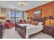 Stylish bedroom with a large bed, seating area, and serene views of the backyard and pool at 15216 W Westview Dr, Goodyear, AZ 85395