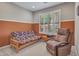 Versatile bedroom with a futon, recliner, and shutters, offering a comfortable and adaptable space at 15216 W Westview Dr, Goodyear, AZ 85395