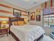 Cozy bedroom with a queen-sized bed, bedside tables, and unique wall decor at 15216 W Westview Dr, Goodyear, AZ 85395
