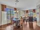 Open concept dining area with wood floors and large windows overlooking the backyard at 15216 W Westview Dr, Goodyear, AZ 85395