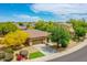 An inviting home exterior features a well-manicured lawn, desert landscaping, and a spacious driveway at 15216 W Westview Dr, Goodyear, AZ 85395