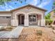 Beautiful front porch with an arched entrance and landscaped flower beds at 15216 W Westview Dr, Goodyear, AZ 85395