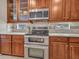 Updated kitchen with double oven, custom cabinets and granite countertops at 15216 W Westview Dr, Goodyear, AZ 85395