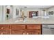 Kitchen island with stainless steel dishwasher and faucet in an open floor plan at 15216 W Westview Dr, Goodyear, AZ 85395
