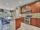 Spacious kitchen with stainless steel appliances, a large island, and custom cabinetry at 15216 W Westview Dr, Goodyear, AZ 85395